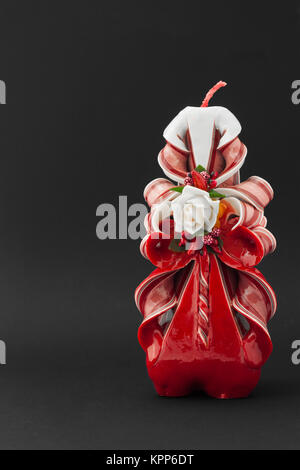 A decorated Christmas candle on a black background Stock Photo