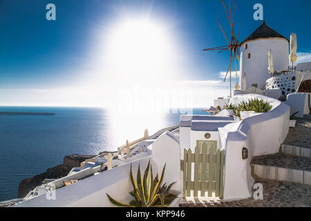 Sunset with windmill in Oia village on Santorini island, Greece. Stock Photo