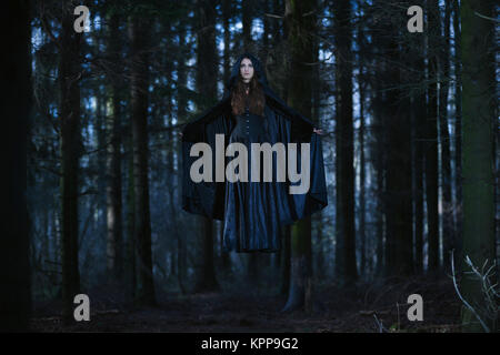 Witch levitating in the forest Stock Photo