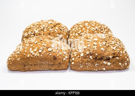 four rolls from wholegrain released on a white background Stock Photo