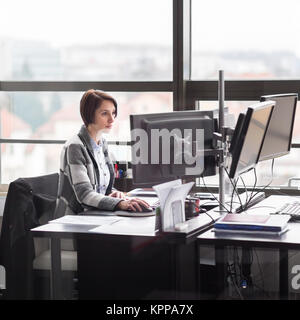 Business woman working in corporate office. Stock Photo