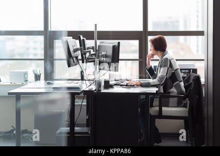 Business woman working in corporate office. Stock Photo