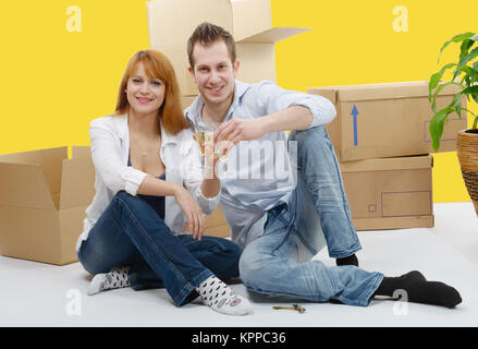 couple celebrating their new home,  and champagne in hand. Stock Photo