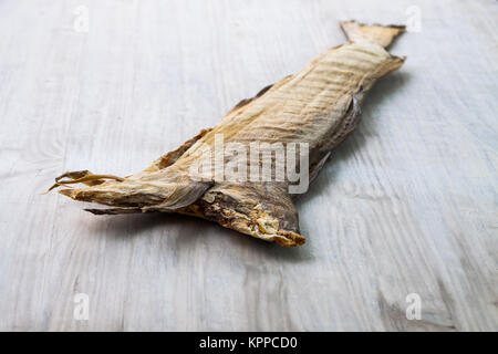 Dry cod fish on white wooden board Stock Photo