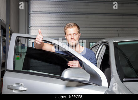 Male hand with spray, car window tint installation process, installing  procedure, tinting film Stock Photo - Alamy