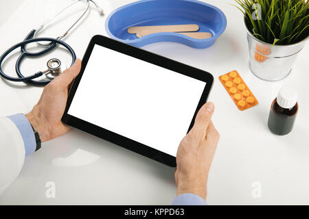 doctor holding blank digital tablet in hands at office Stock Photo