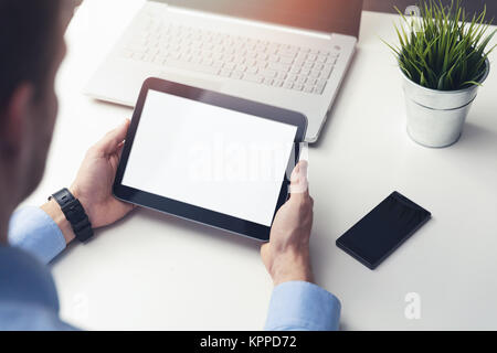 businessman holding blank digital tablet in hands on table at office Stock Photo