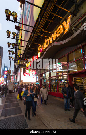 View of Times Square 42nd Street Subway entrance exterior with pedestrians walking on pavement outside, New York, USA Stock Photo