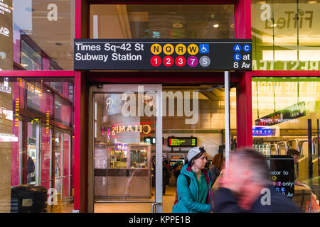 View of Times Square 42nd Street Subway entrance exterior with pedestrians walking on pavement outside, New York, USA Stock Photo