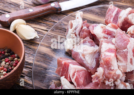 diced bacon raw meat in a plate, on a wooden board Stock Photo