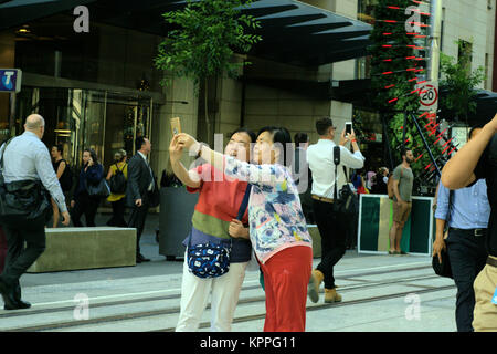 Two Asian women taking selfie at George St in Sydney Australia. Asian tourists in Australia. Outdoors Sydney Australia Daytime Image Stock Photo