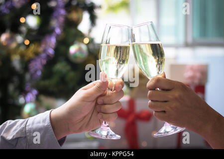 Christmas party drinking concept, glass of champagne with gift box on bokeh background Stock Photo