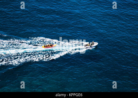 Motor boat Pull Fun Tube on sea in Gran Canaria, Spain. Stock Photo