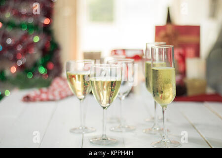 Christmas party drinking concept, glass of champagne with gift box on bokeh background Stock Photo
