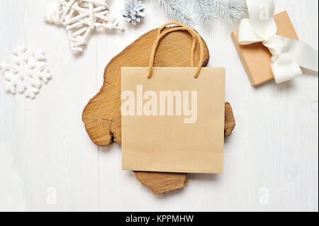 Mockup Christmas craft package and gift, flatlay on a white wooden background, with place for your text Stock Photo