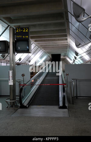 An escalator leading into darkness in the abandoned Waterloo Eurostar train terminal in London Stock Photo