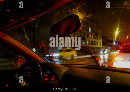 Driving a car in a city street under a heavy rain, Lyon, France Stock Photo