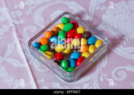 Multi colored sweets . Colored candy in a glass . Round chocolate is very colorful Stock Photo