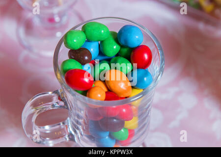 Multi colored sweets . Colored candy in a glass . Round chocolate is very colorful Stock Photo