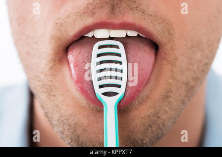 Man Cleaning Her Tongue Stock Photo