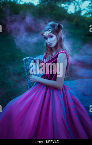 Elf woman in violet dress Stock Photo