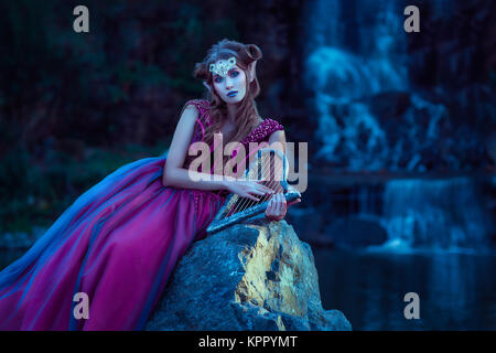 Elf woman in violet dress Stock Photo