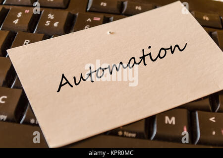 Automation - note on keyboard in the office Stock Photo