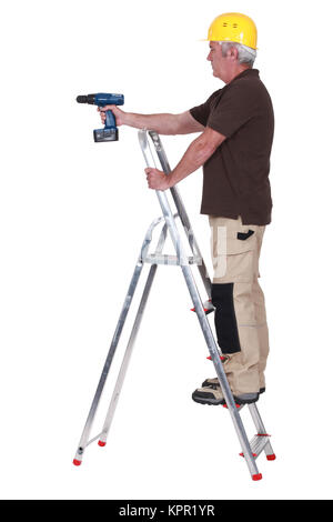 Labourer using a cordless screwdriver Stock Photo
