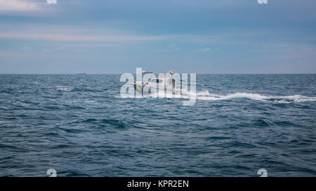 boat floating on waves of the sea Stock Photo