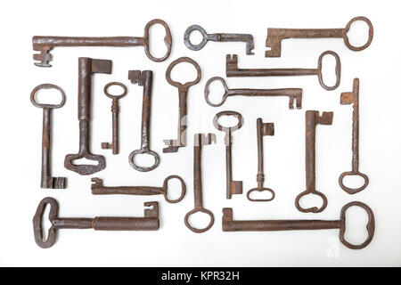 Vintage forging iron rusty keys collection isolated on white background Stock Photo