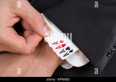 Businessman Removing Ace Cards From Sleeve Stock Photo