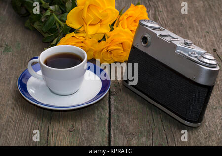 still life on a retro, the camera, roses and coffee Stock Photo