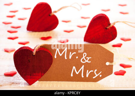 Romantic Label With Many Hearts. English Text Mr. And Mrs. Wooden Background And Retro Or Vintage Style. Stock Photo