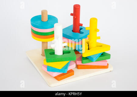 Colorful puzzle wooden toy on white table Stock Photo