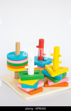 Colorful puzzle wooden toy on white table Stock Photo