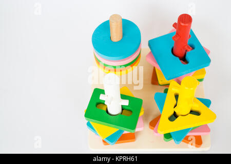 Colorful puzzle wooden toy on white table Stock Photo