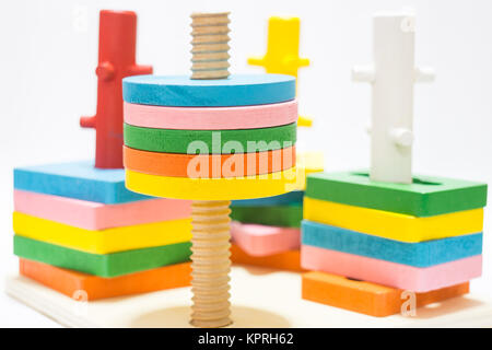 Colorful puzzle wooden toy on white table Stock Photo