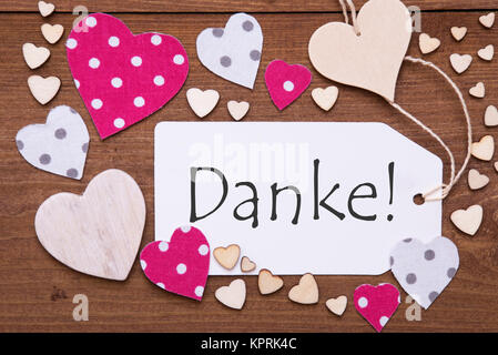 Label With Pink Textile Hearts On Wooden Background. German Text Danke Means Thank You. Retro Or Vintage Style Stock Photo