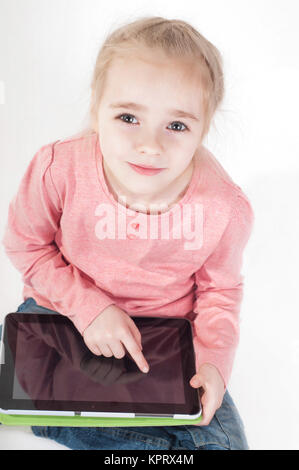 Little girl uses a tablet PC Stock Photo