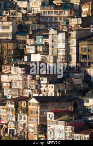 Tiered houses and ramshackle buildings on steep hillside in Shimla, India Stock Photo