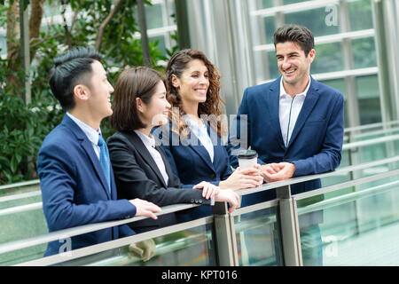 Group of business people chatting outside office in Hong Kong Stock Photo