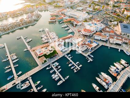 Aerial view of the beautiful Marina in Limassol city in Cyprus, the beach, boats, piers, villas and commercial area. A very modern, high end and newly developed space where yachts are moored and it's perfect for a waterfront promenade. Stock Photo