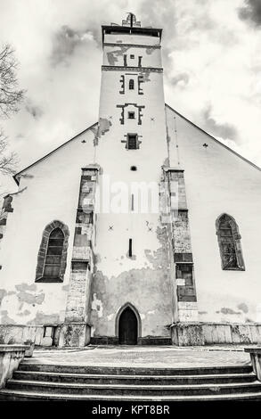 Basilica of the Holy Cross in Kezmarok city, Slovak republic. Religious architecture. Travel destination. Black and white photo. Stock Photo