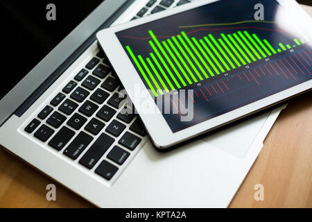 Tablet computer showing charts and diagram Stock Photo