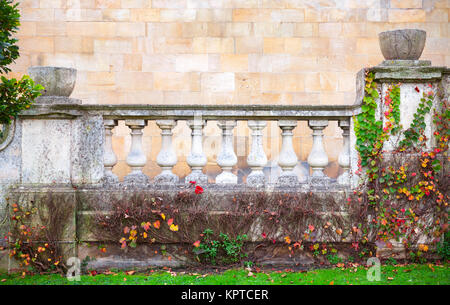 Old white handrail with balusters in summer English garden Stock Photo