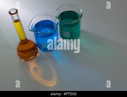 High angle view of laboratory glassware with liquid chemicals isolated over gray background Stock Photo