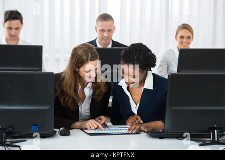 Two Businesswomen Discussing On Graph Stock Photo