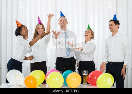Businesspeople Standing Under Falling Confetti Stock Photo
