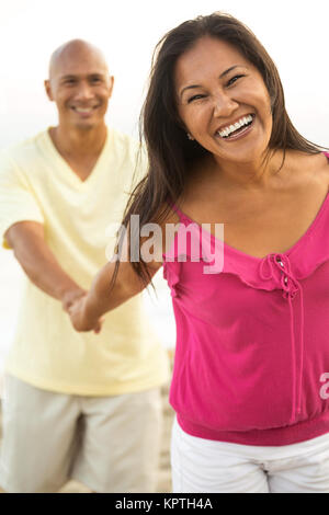 Couple on the beach smiling. Stock Photo