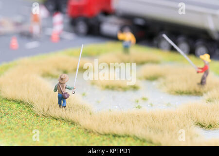 Miniature anglers near road close-up Stock Photo